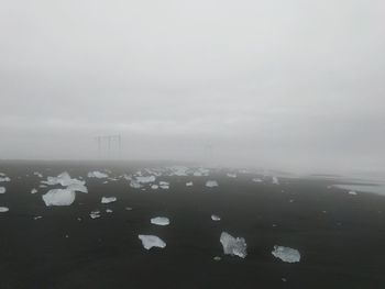 Scenic view of sea against sky during winter