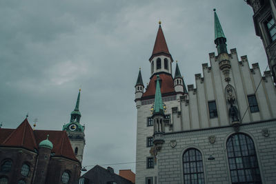 Low angle view of bell tower against cloudy sky
