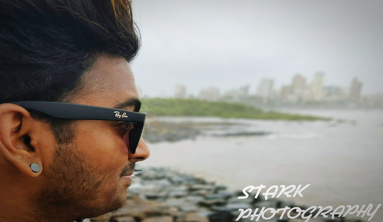 lifestyles, headshot, leisure activity, person, focus on foreground, young adult, close-up, head and shoulders, casual clothing, young men, water, looking at camera, portrait, beach, smiling, front view