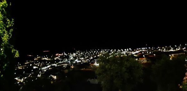 High angle view of illuminated buildings in city at night