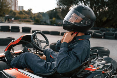 Side view of man sitting in car