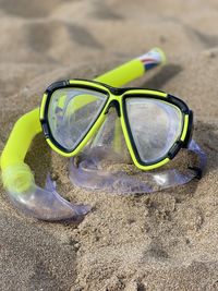 Close-up of sunglasses on beach