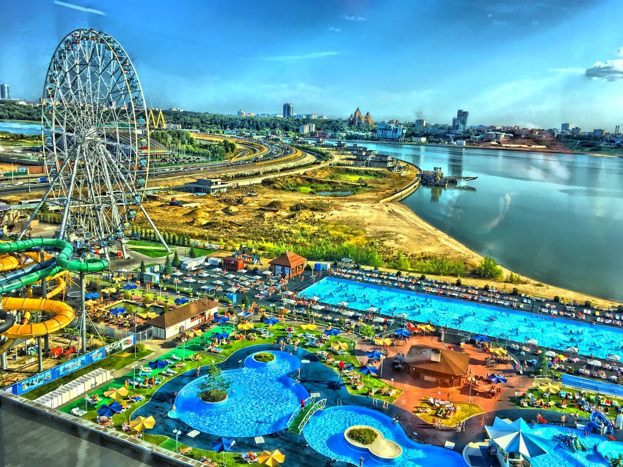 HIGH ANGLE VIEW OF SWIMMING POOL IN PARK AGAINST SKY