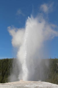 Scenic view of waterfall against sky