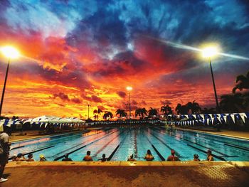 View of swimming pool at sunset