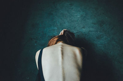 Close-up of woman relaxing on wall