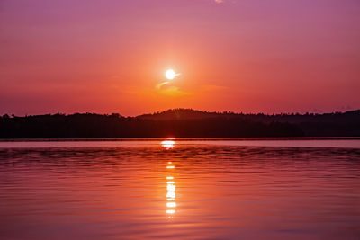 Scenic view of lake against romantic sky at sunset