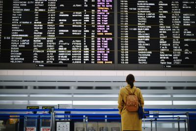 Rear view of woman standing at airport