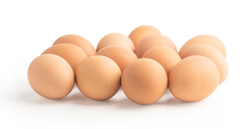 Close-up of eggs against white background