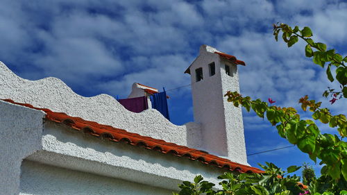 Low angle view of building roof against sky