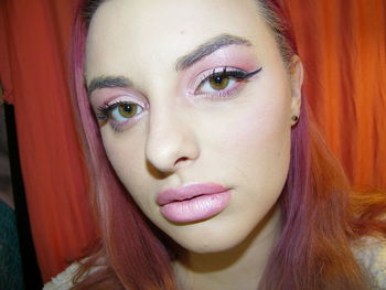 Close-up portrait of beautiful woman wearing make-up at home