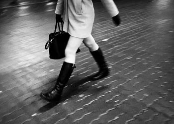 Low section of woman walking on floor