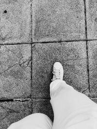 Low section of woman standing on tiled floor