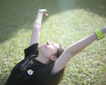 Young woman lying on grass