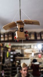 Low angle view of handmade toy hanging in store