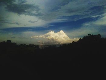Silhouette of landscape against cloudy sky