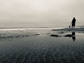 Man on beach against sky