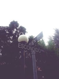 Low angle view of information sign against clear sky