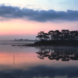 Scenic view of lake against sky during sunset