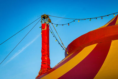 Low angle view of tent against clear blue sky