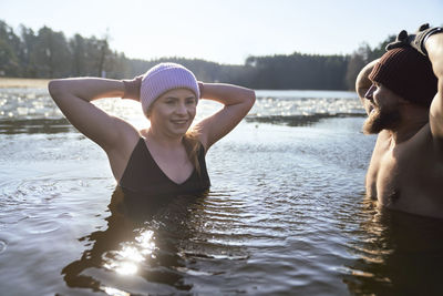 Young couple in lake during sunrise