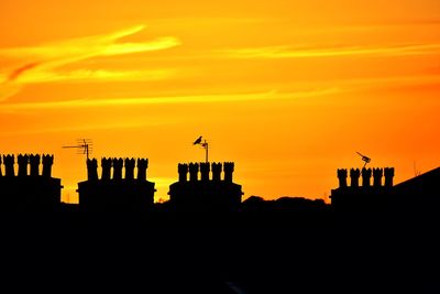 Silhouette of built structure at sunset