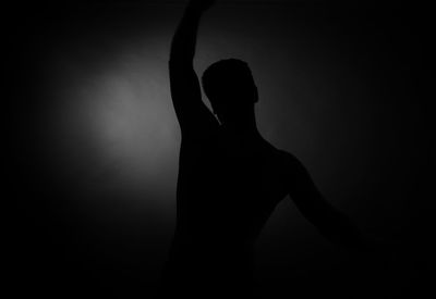 Silhouette of man against black background