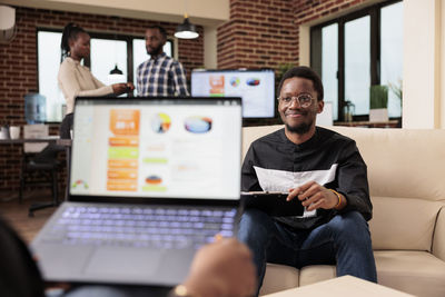 Young man using laptop at office