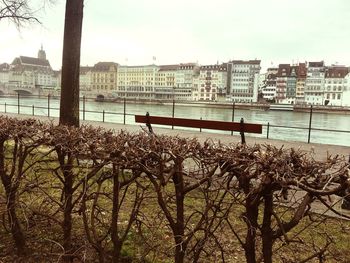 Scenic view of river by city against clear sky