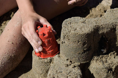 High angle view of baby hand holding toy