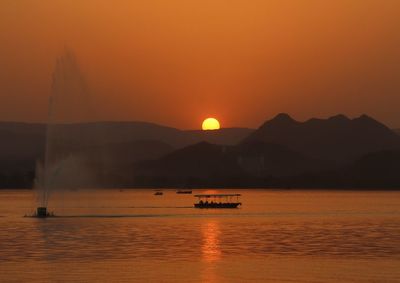 Scenic view of sea against orange sky