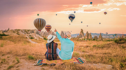 Hot air balloons flying over landscape