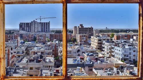 High angle view of buildings in city against clear sky