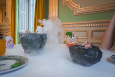 Rear view of woman sitting on table