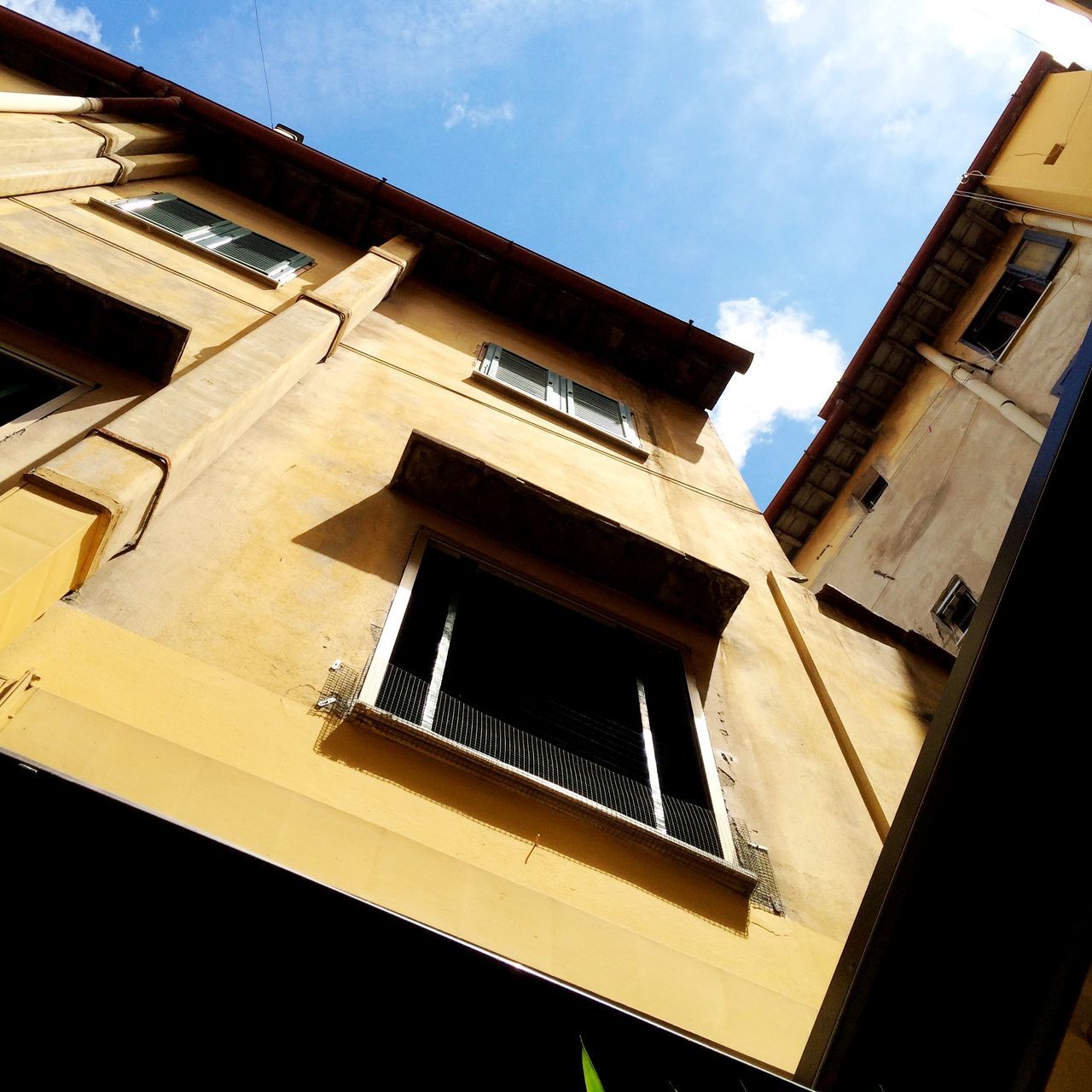 architecture, building exterior, built structure, low angle view, window, residential building, building, sky, residential structure, city, no people, outdoors, day, tilt, house, sunlight, directly below, balcony, cloud, cloud - sky