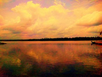 Scenic view of lake against orange sky