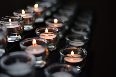 Close-up of burning candles in temple