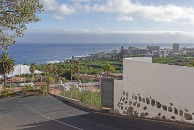 High angle view of buildings by sea against sky