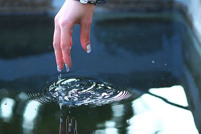 Close-up of hand touch the water