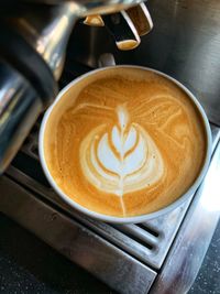 Close-up of cappuccino on coffee cup