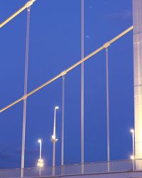 Low angle view of illuminated built structure against blue sky