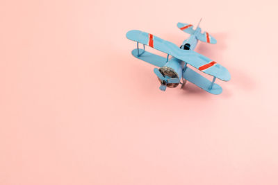 High angle view of toy airplane over colored background