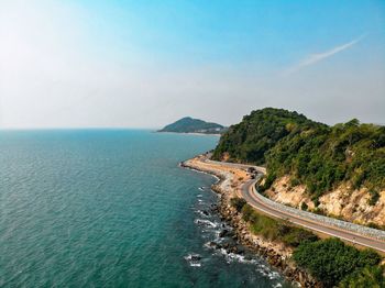 Road cut off the sea and mountains. the blue sea along the way.aerial photos