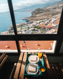 High angle view of breakfast on table by sea