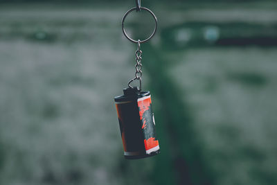 Close-up of red chain hanging on metal structure