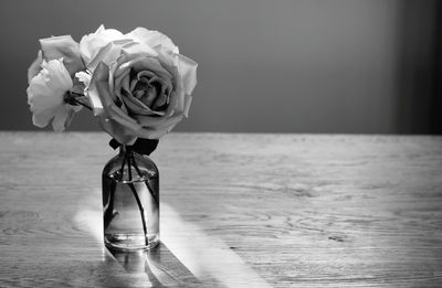 Close-up of rose in vase on table