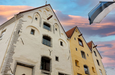 Low angle view of building against cloudy sky