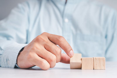 Midsection of man with toy on table