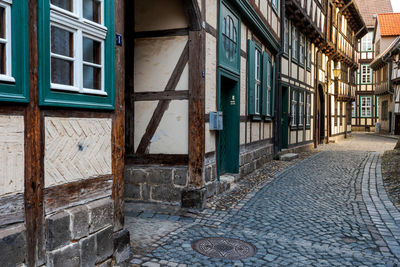 Empty street amidst buildings in city