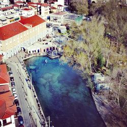 High angle view of swimming pool by buildings in city